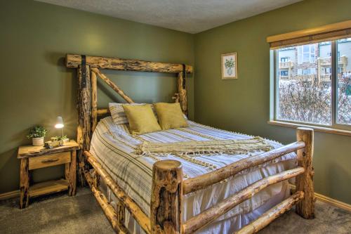 a bedroom with a wooden bed and a window at Cozy Eden Condo with Mtn Views in Wolf Creek Resort! in Eden