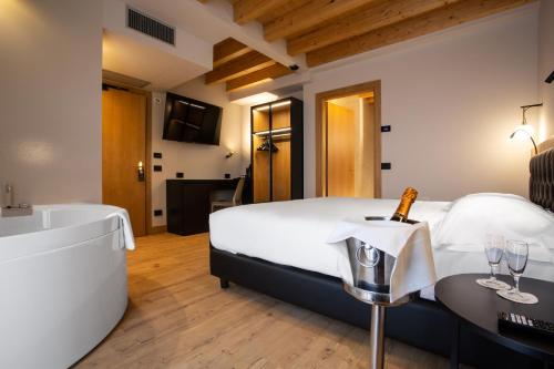a hotel room with a bed and a bath tub at Hotel Master in Brescia