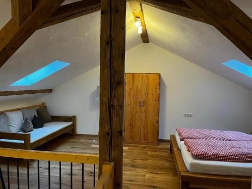 a bedroom with a bed and a bunk room with wooden beams at Thallerhof in Griesstätt