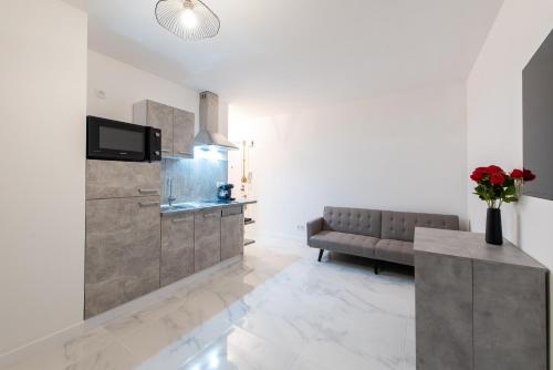 a living room with a couch and a table at VILLA CLIPPER in Juan-les-Pins
