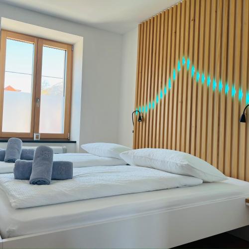 a room with three beds with a line graph on the wall at Emerald Valley Apartments in Bovec