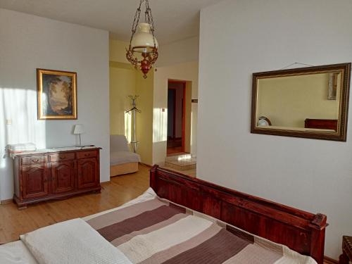 a bedroom with a bed and a mirror on the wall at Willa Rosa in Kajetany