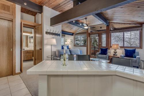 a kitchen with a large island in a living room at Laurelwood Condominiums 112 in Snowmass Village