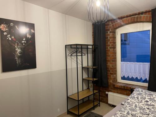 a bedroom with a black book shelf next to a window at Apartment Hildesheim in Hildesheim