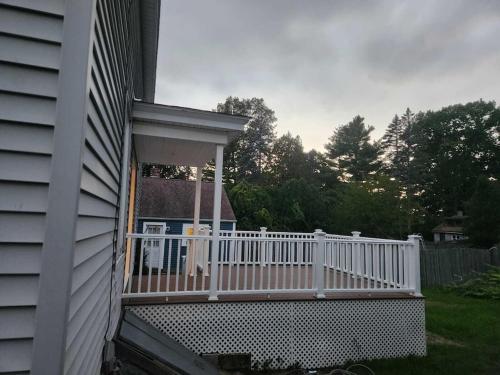 a porch with a white fence on the side of a house at Newly updated 3 bedrooms luxury house in Worcester