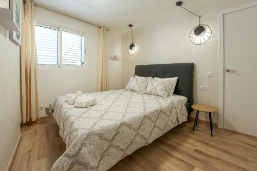 a bedroom with a bed with two towels on it at Royal Apartment Las Américas near the beach in Playa Fañabe
