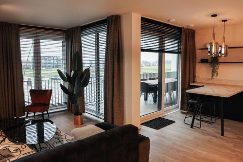 a living room with a couch and a dining room at Luxe loft appartement in Résidence Marina Kamperland (8 pers.) in Kamperland