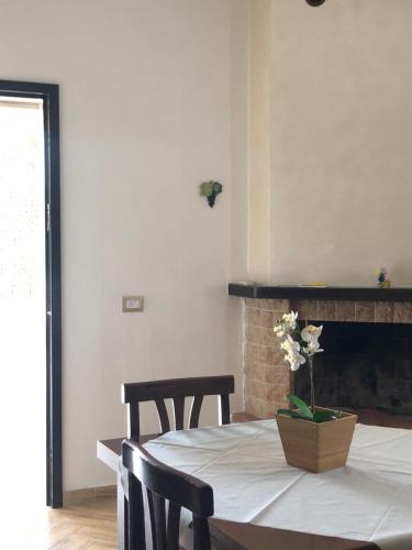 a dining room with a table and a fireplace at Casa Giulia in Niscemi