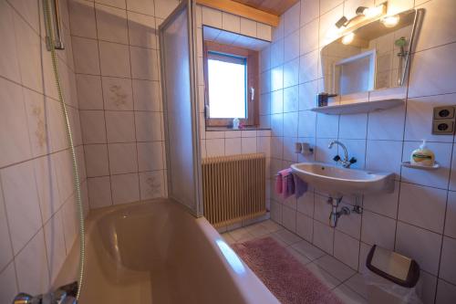 a bathroom with a tub and a sink at Haus Carmen in Stumm