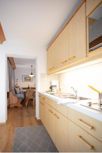 a kitchen with a sink and a counter top at Ferienwohnungen Wolf in Holzgau