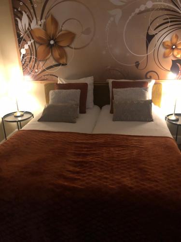 a bedroom with a large bed with two lamps at Maison de la Comtesse in Cosne-dʼAllier