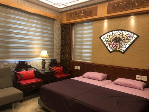 a bedroom with two beds and a stained glass window at 瑜家 Yoga Home in Chiayi City