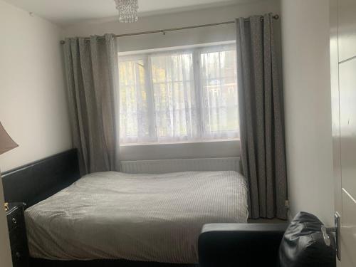 a small bedroom with a bed and a window at Charming Home in Sevenoaks in Kent