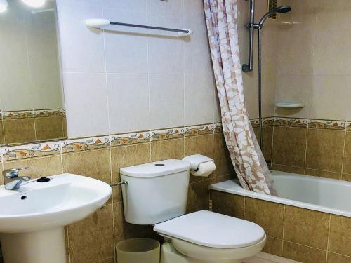 a bathroom with a toilet and a sink and a shower at Dona Lola Martha - Spacious 3 bedroom apartment with partial sea views in Mijas