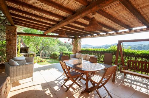 a patio with a table and chairs on a deck at Chia Soul Home in Chia