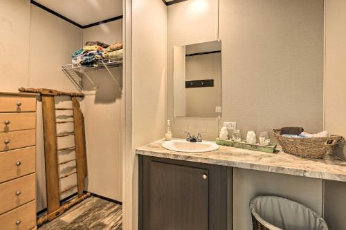 a bathroom with a sink and a mirror at Lakefront Wetumpka Escape with Furnished Deck! in Wetumpka