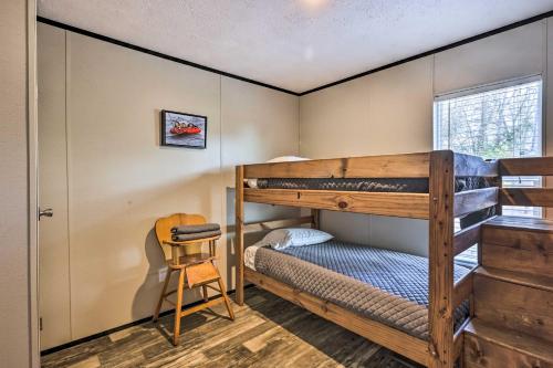 a bedroom with two bunk beds and a chair at Lakefront Wetumpka Escape with Furnished Deck! in Wetumpka