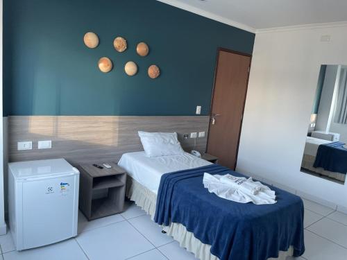 a hotel room with a bed and a trash can at Hotel Center Vitoria in Vitória de Santo Antão