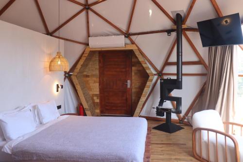 a bedroom with a bed and a wooden floor at Mandalin Glamping in Selcuk