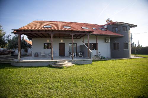 a small house with a roof on a yard at Countryside luxury studios in Káto Lekhónia