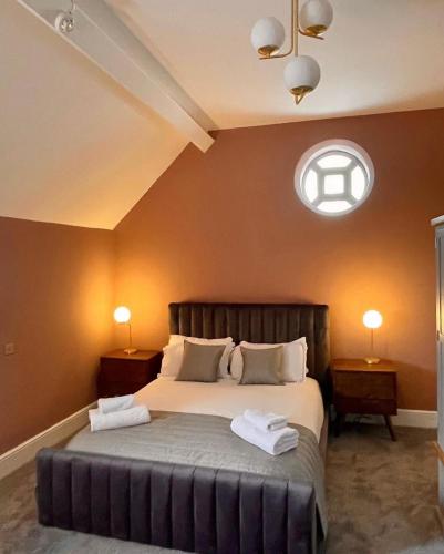 a bedroom with a large bed with two towels on it at The Spa Hotel in Saltburn-by-the-Sea