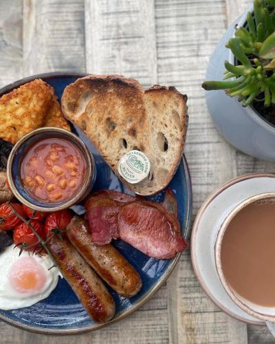 a plate of breakfast food with eggs bacon and toast at The Spa Hotel in Saltburn-by-the-Sea