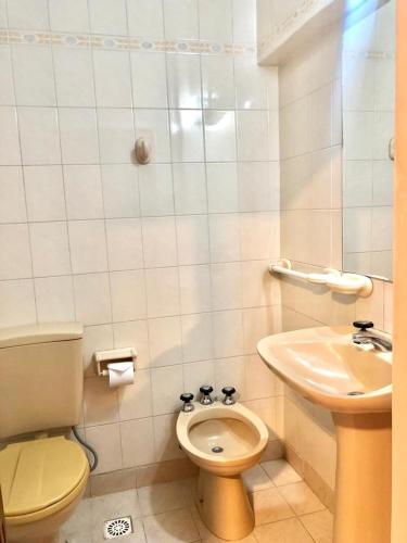 a small bathroom with a toilet and a sink at Hotel Bonino in Villa Mercedes