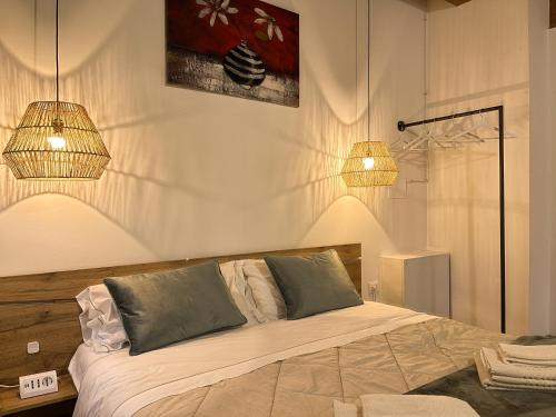 a bedroom with a bed with two lights on it at Agriturismo Vecio Portico in Marostica