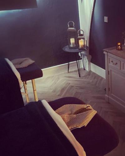 a bedroom with a bed and a table with a candle at The Spa Hotel in Saltburn-by-the-Sea