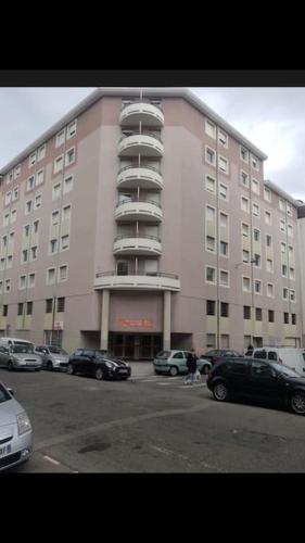 un grand bâtiment avec des voitures garées devant lui dans l'établissement Studio quartier du port Nice, à Nice