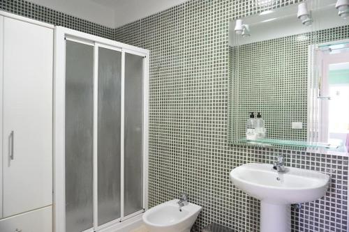 a bathroom with a sink and a glass shower at South Coast Apartment in Puertito de Güímar