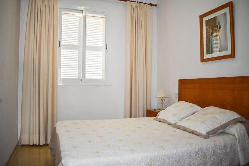 a bedroom with a large bed and a window at Apartamento Maria,Bahía de Alcudia in Alcudia
