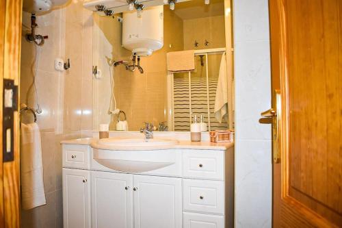 a bathroom with a sink and a mirror at Apartamento Maria,Bahía de Alcudia in Alcudia