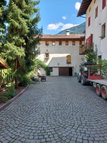 a stone driveway in front of a building at Ansitz von Wohlgemuth in Salorno sulla Strada del Vino