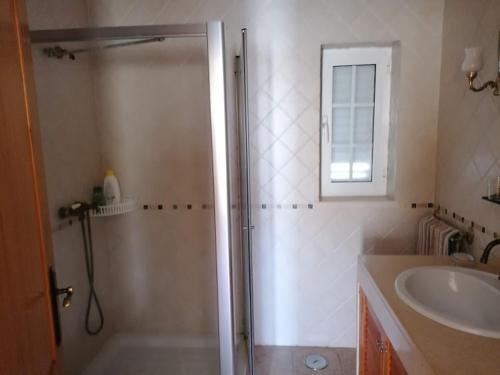 a bathroom with a shower and a sink at Casa da Carrasqueira - Sesimbra in Sesimbra