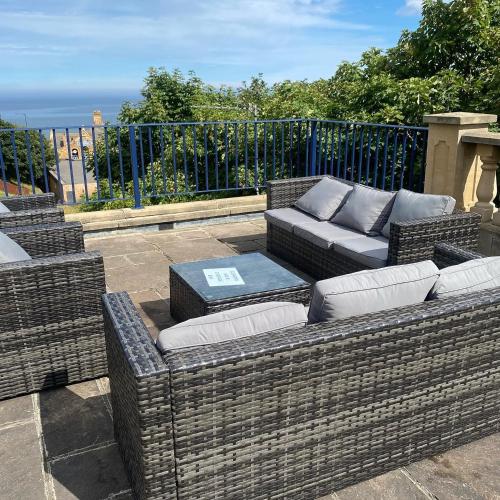 a patio with two wicker couches and a table at The Spa Hotel in Saltburn-by-the-Sea