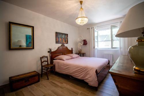 um quarto com uma cama, uma mesa e um candeeiro em Appartement avec Rivière privative em Tourrettes