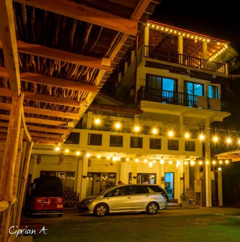 a car parked in front of a building at night at Chill House make a Good Story with infinite Ocean Surf and Stay in Weligama