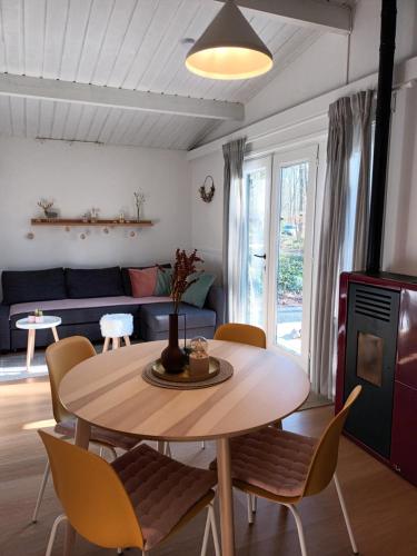 a living room with a table and chairs and a couch at à l´aise in Petit Mesnil
