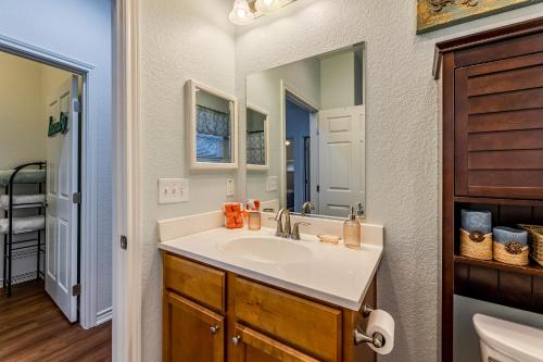 a bathroom with a sink and a mirror at Little Blue House on Lonnie Lane in Houston