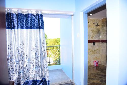 a door with a curtain in a room with a window at Thangam Residency in Kāraikkudi