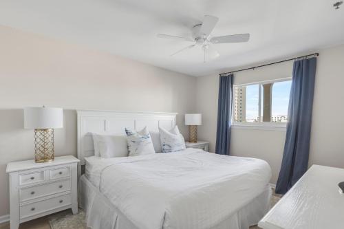 a white bedroom with a white bed and a window at Windancer 304 in Destin