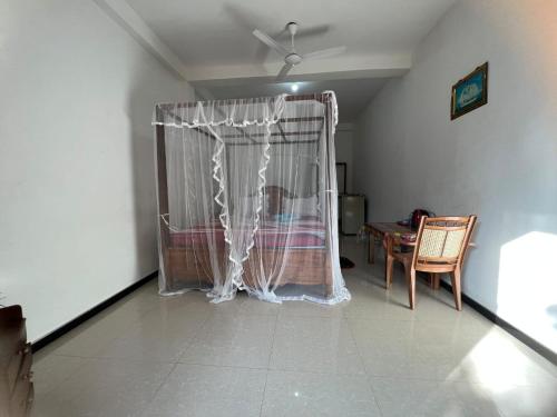 a room with a crib in the corner of a room at Resort of Happiness in Mirissa