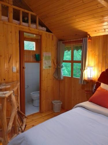 a bedroom with a bed and a toilet in a room at Casa Mujer Villa Agueda in Chocontá