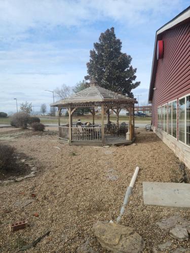 a wooden gazebo in a yard next to a building at Comfort Inn & Suites in Shelbyville
