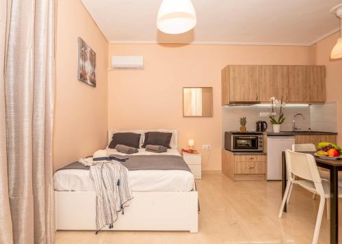 a small bedroom with a bed and a kitchen at COZY STUDIO in RETHYMNO TOWN in Rethymno
