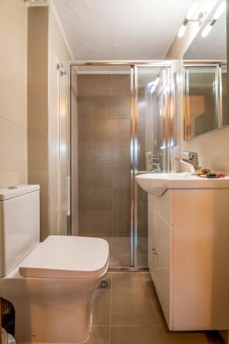 a bathroom with a toilet and a sink and a shower at COZY STUDIO in RETHYMNO TOWN in Rethymno