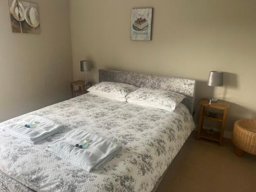 a bedroom with a bed with two towels on it at Coach and Horses INN in Penzance