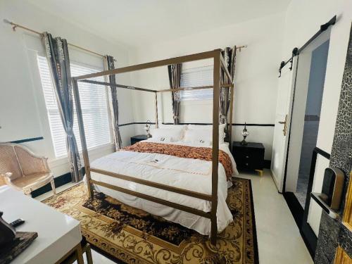 a bedroom with a canopy bed in a room at Prestige Collection, Hotel Boutique in St. Petersburg