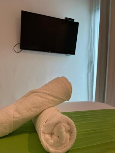 a roll of toilet paper sitting on top of a bed at Hotel MAYARI Holbox in Holbox Island